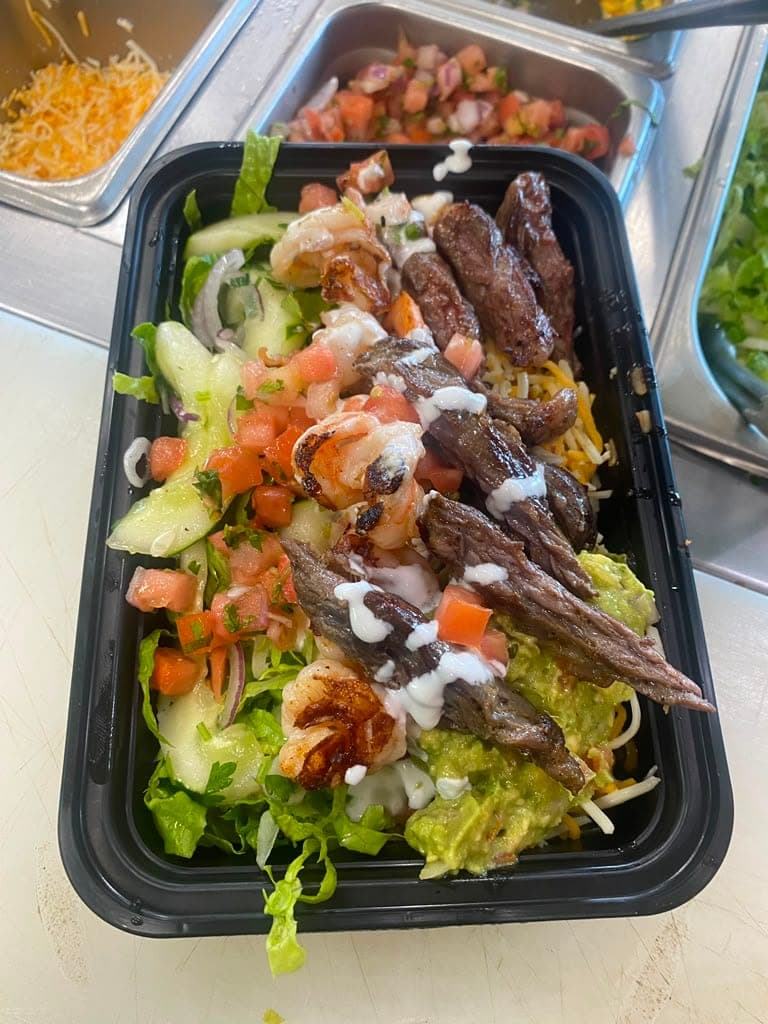 Carne asada bowl with rice, cheese and pico de gallo