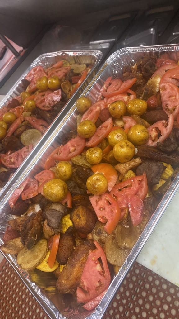 Catering tray of grilled parrillada with plantains and potatoes