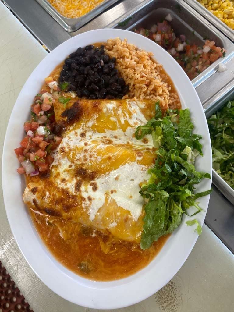 Chicken enchiladas plate with rice, beans and salsa verde