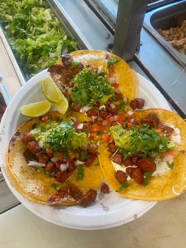 Chorizo tacos topped with guacamole and pico de gallo