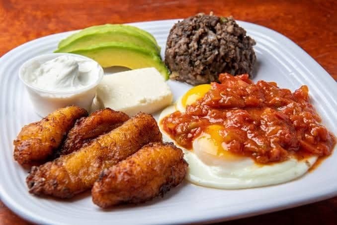 Traditional Latin breakfast plate with eggs, plantains, avocado and rice