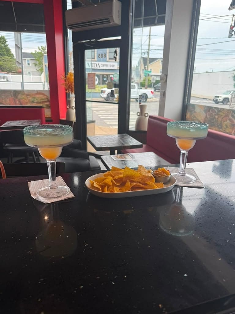 Margaritas and tortilla chips with salsa at the table