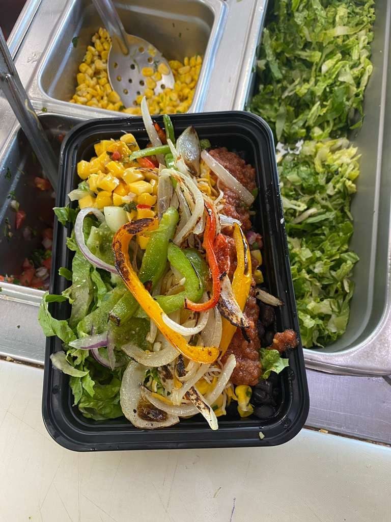 Steak and shrimp salad bowl with pico de gallo and cucumber