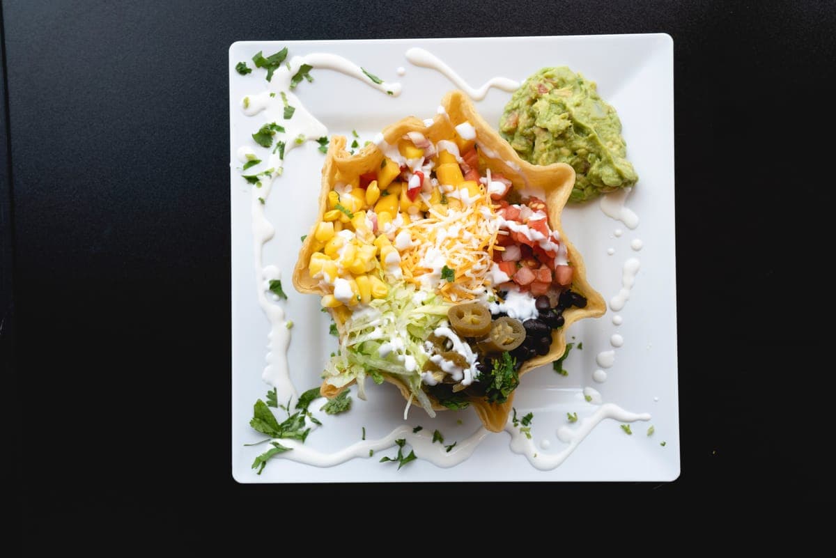 Taco salad bowl with guacamole, corn and black beans